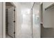 Hallway with tiled floors, closet with mirror and storage leading to the Primary bathroom at 10895 E Mission Ln, Scottsdale, AZ 85259