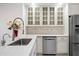 Bright kitchen features white cabinetry, stainless steel appliances, and a large sink at 10895 E Mission Ln, Scottsdale, AZ 85259