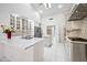 This stylish kitchen features white cabinets, stainless steel appliances, and a center island with quartz countertops at 10895 E Mission Ln, Scottsdale, AZ 85259