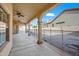 Covered patio features ceiling fans, concrete flooring, and a gated pool area for outdoor enjoyment at 10895 E Mission Ln, Scottsdale, AZ 85259