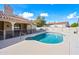 Beautiful backyard pool complemented by covered patio and mature trees provides a private retreat at 10895 E Mission Ln, Scottsdale, AZ 85259