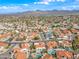 Aerial view of the community, showcasing houses with pools, lush landscaping, and mountain views at 10895 E Mission Ln, Scottsdale, AZ 85259