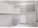 Spacious walk-in closet featuring custom shelving, drawers, and ample hanging space for organized storage at 10895 E Mission Ln, Scottsdale, AZ 85259