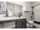 Modern bathroom with stylish vanity, large mirror, and combined shower-tub at 11441 W La Reata Ave, Avondale, AZ 85392