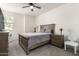 Inviting bedroom with neutral color palette, ceiling fan, and side tables at 11441 W La Reata Ave, Avondale, AZ 85392