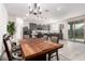 Elegant dining area with a large table and views into the modern kitchen at 11441 W La Reata Ave, Avondale, AZ 85392