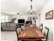 Open dining area with a wooden table and chairs, adjacent to the living room and kitchen at 11441 W La Reata Ave, Avondale, AZ 85392