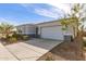 A long driveway is shown to the two-car garage on the side of this single-story home at 11441 W La Reata Ave, Avondale, AZ 85392