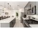 Modern kitchen showcases stainless steel appliances, quartz countertops and an island with counter seating at 11441 W La Reata Ave, Avondale, AZ 85392