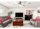 Cozy living room with a large television, an electric fireplace, and grey couches and chairs at 11441 W La Reata Ave, Avondale, AZ 85392