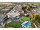 Aerial view of a beautiful home featuring a pool, outdoor living space, and lush landscaping at 1180 E Ibis St, Gilbert, AZ 85297