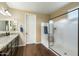 Well-lit bathroom featuring a dark vanity with granite countertops and a glass shower at 1180 E Ibis St, Gilbert, AZ 85297