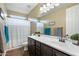 Bathroom featuring a double sink vanity with dark wood cabinetry and tile floors at 1180 E Ibis St, Gilbert, AZ 85297