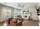 Beautiful living room showcasing a modern fan, lots of natural light, and comfortable, contemporary furnishings at 1180 E Ibis St, Gilbert, AZ 85297