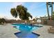 Backyard pool with a baja step, built-in spa, fire bowls, basketball court, and lounge chairs at 1180 E Ibis St, Gilbert, AZ 85297