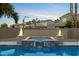 Sparkling pool with fire bowls providing a luxurious and inviting outdoor space at 1180 E Ibis St, Gilbert, AZ 85297