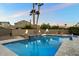 Backyard swimming pool featuring built-in spa, water feature, fire bowls and basketball court at 1180 E Ibis St, Gilbert, AZ 85297