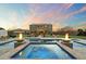 Stunning pool and spa with fire bowls and beautiful backyard at dusk at 1180 E Ibis St, Gilbert, AZ 85297