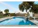 Swimming pool with basketball hoop, water feature, fire bowls, and lounge chairs at 1180 E Ibis St, Gilbert, AZ 85297