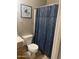 Bathroom featuring modern fixtures, toilet, and a shower with a stylish shower curtain at 12510 W Wells St, El Mirage, AZ 85335