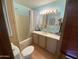 A clean bathroom with linoleum flooring, a tub/shower combination, and a blue accent wall at 1281 S Sioux Dr, Apache Junction, AZ 85119