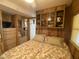 A bedroom featuring paneled walls, a ceiling fan, a floral bedspread, and built-in storage at 1281 S Sioux Dr, Apache Junction, AZ 85119