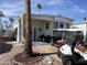 Exterior of a manufactured home featuring a covered patio with seating, parking with golf cart, and desert landscaping at 1281 S Sioux Dr, Apache Junction, AZ 85119