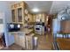 Open floorplan kitchen with wood cabinetry, laminate flooring, and a serving counter with stools at 1281 S Sioux Dr, Apache Junction, AZ 85119