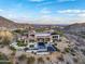 Breathtaking aerial view of a sprawling home with a pool, outdoor entertainment areas, and desert surroundings at 13808 S Canyon Dr, Phoenix, AZ 85048