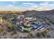 Stunning aerial view of a luxury home nestled in the mountains, showcasing its pool and outdoor living spaces at 13808 S Canyon Dr, Phoenix, AZ 85048