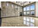 Indoor basketball court featuring a concrete wall, modern windows, and a hardwood floor at 13808 S Canyon Dr, Phoenix, AZ 85048