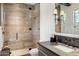 Elegant bathroom featuring a walk-in shower with wood-look tile and a sleek vanity at 13808 S Canyon Dr, Phoenix, AZ 85048