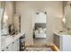 Elegant primary bathroom featuring dual vanities, makeup area, and doorway to bedroom at 13808 S Canyon Dr, Phoenix, AZ 85048