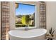 Soaking tub with scenic views of the mountains and desert landscape at 13808 S Canyon Dr, Phoenix, AZ 85048