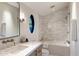 Bright bathroom featuring a bathtub with tile surround, unique oval window, and modern vanity at 13808 S Canyon Dr, Phoenix, AZ 85048