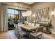 Bright dining area with a large window, modern chandelier, and seating for eight around the table at 13808 S Canyon Dr, Phoenix, AZ 85048