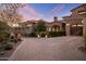 Stunning stone home featuring a large brick driveway and lush landscaping at 13808 S Canyon Dr, Phoenix, AZ 85048