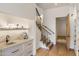 Hallway with wet bar, staircase with wrought iron railing, and a decorative wood door at 13808 S Canyon Dr, Phoenix, AZ 85048