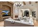 Elegant living room features a stone fireplace, beamed ceilings, and a comfortable white sectional sofa at 13808 S Canyon Dr, Phoenix, AZ 85048