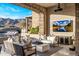 Relaxing outdoor seating area with a beautiful stone fireplace and scenic mountain views at 13808 S Canyon Dr, Phoenix, AZ 85048