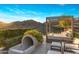 Relaxing patio area with a unique slide feature, lounge bed, and beautiful mountain scenery at 13808 S Canyon Dr, Phoenix, AZ 85048