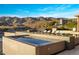 Contemporary pool area with lounge chairs, fire feature, and desert mountain views at 13808 S Canyon Dr, Phoenix, AZ 85048