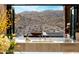 Stainless steel kitchen sink with bi-fold windows opening to an outdoor kitchen and valley views at 13808 S Canyon Dr, Phoenix, AZ 85048