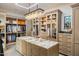 Spacious walk-in closet with custom shelving, island, and chandelier lighting at 13808 S Canyon Dr, Phoenix, AZ 85048