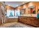 Spacious bathroom with a soaking tub, double sinks and custom wood cabinets at 14215 E Calle De Las Estrellas Dr, Scottsdale, AZ 85262