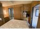 View of bedroom with bed, closet, and wooden cabinets at 1506 S Omaha Dr, Apache Junction, AZ 85119