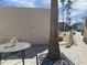 Outdoor living space with a table, palm tree, and charming landscape at 1506 S Omaha Dr, Apache Junction, AZ 85119