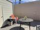 Outdoor patio area featuring table, stacked chairs, and a trash can at 1506 S Omaha Dr, Apache Junction, AZ 85119