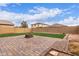 Large backyard with brick-paved patio and artificial turf, ideal for outdoor relaxation and activities at 16789 W Moreland St, Goodyear, AZ 85338