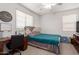 Comfortable bedroom with a ceiling fan and a desk area at 16789 W Moreland St, Goodyear, AZ 85338